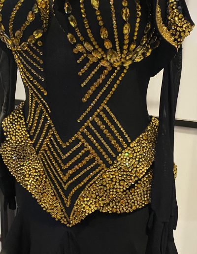 Close up of the Black and Gold Couture Gown showing the design of the waist.