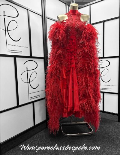Front of a Red feathered Couture Gown.