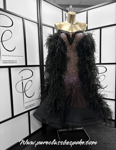 A Black feathered couture gown.