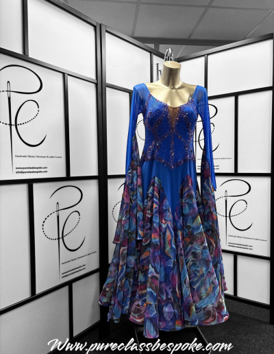 Front of a blue and patterned couture gown.