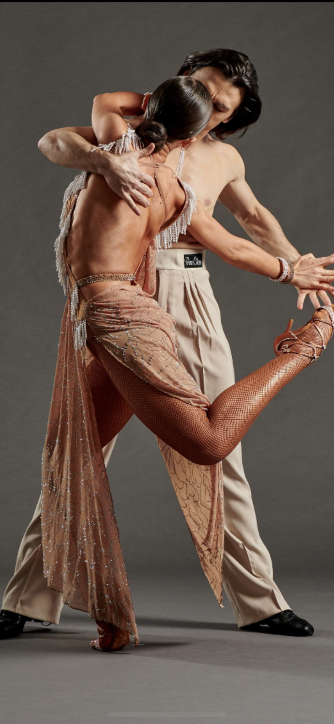 Two dancers, wearing Pure Class Bespoke attire.